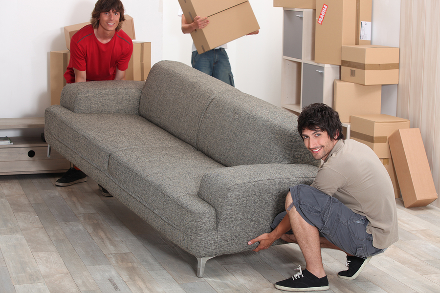 Moving and storage of furniture photo of 2 men lifting a couch